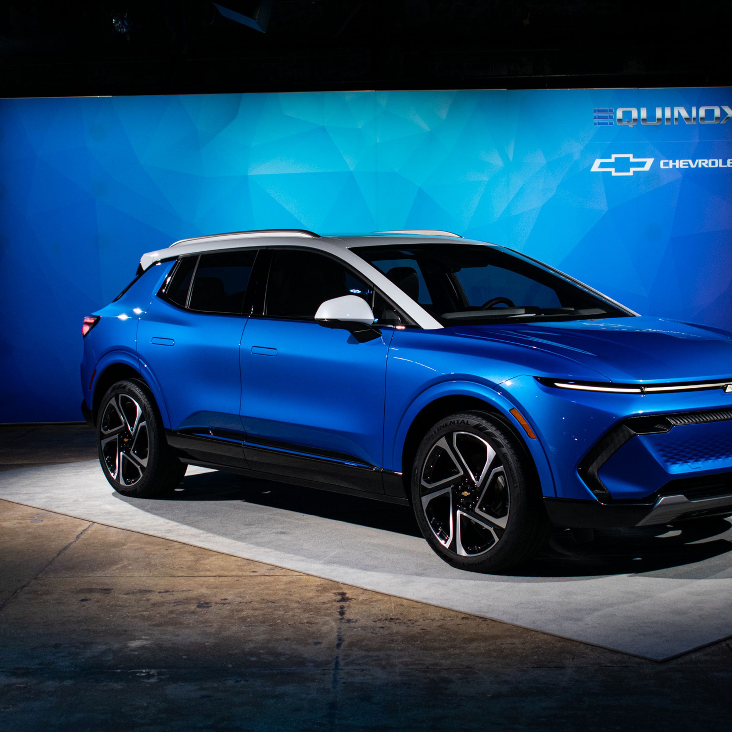 The blue Chevy Equinox electric vehicle sitting in a showroom.