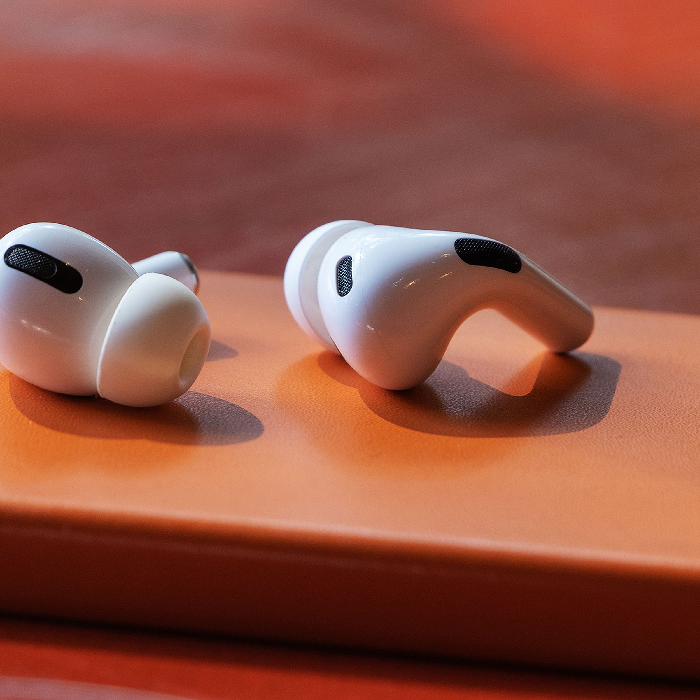 AirPods Pro 2022 model sitting on an orange pedestal.