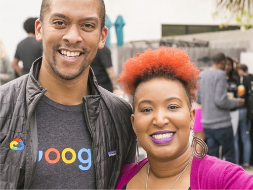 A man and woman looking at the camera