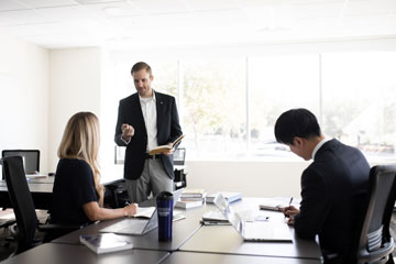 three people in a Student Journal work session at Pepperdine Caruso Law