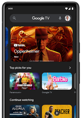 A mobile phone with the Google TV app on the screen.