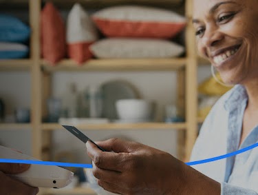 A woman using her credit card at an interior design store