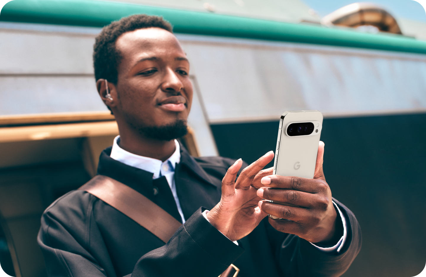 A man working on his Google Pixel 9 Pro XL phone on the go.