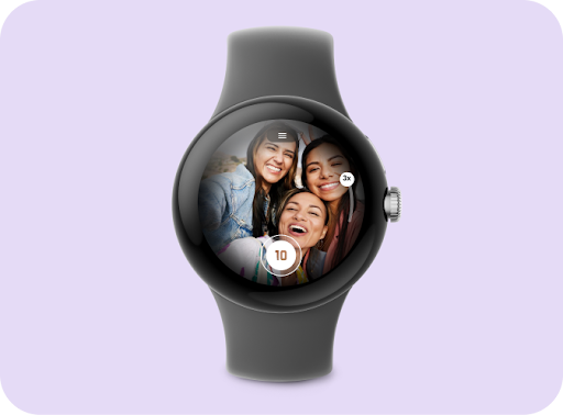 A smartwatch displaying an image of 3 smiling friends on the screen with a camera button and zoom control.