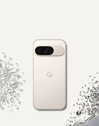 Back of Pixel 9 in Porcelain color against a porcelain-colored background, surrounded by glass and metal shards.