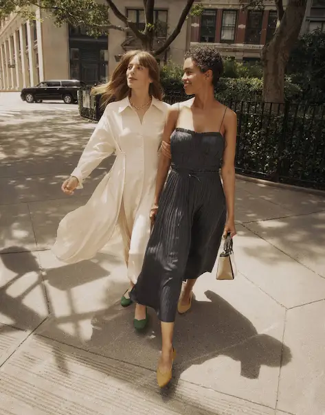 Two women walking in a metropolitan area in the afternoon.