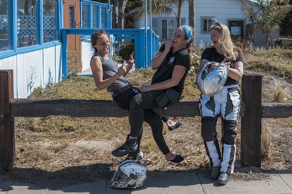 Three women chatting and smiling together.