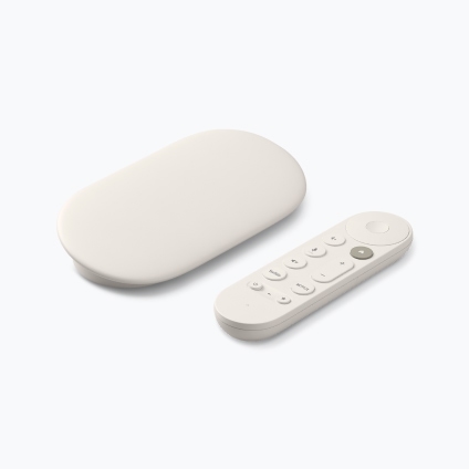 White-colored Google tv streamer with remote against a white background.