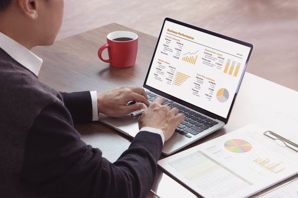 An investor performing a business valuation on a laptop.