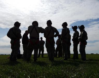 a group of personnel in body armor stand in circle