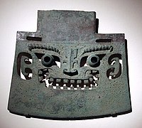 A yue bronze axe with head motif, dated to the Shang