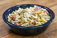 Macaroni salad is a type of pasta salad typically served cold with a mayonnaise dressing.