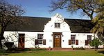 The so-called Rust-en-Vrede building complex, which dates predominantly from the mid nineteenth century, reflects a harmonious blending of Cape Dutch, Georgian and Victorian architectural elements. Since its erection the complex has served as a prison, a