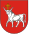 A coat of arms depicting a white bull with an angry expression and a golden cross protruding from its head all on a red background