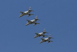 Four monoplane aircraft flying in close formation. The aircraft are painted grey and have been photographed from below.