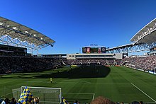 A filled open air soccer stadium