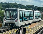 A Bombardier Innovia APM 300R C801B running on the guiderails.