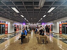 Underground platforms of the NEL, with calligraphic writing on the floor along the length of each platform.