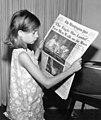 Image 14A girl reading a 21 July 1969 copy of The Washington Post reporting on the Apollo 11 Moon landing (from Newspaper)