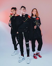 Chase Atlantic holding roses in a 2018 photoshoot.