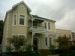 Late Victorian style double storey house. Hipped and gabled pitched roof with fibre cement slates. Double storey bay to left hand side of facade. Double storey cast iron filigree verandah at entrance of which a portion remains. Ashlar plasterwork, These two impressive double-storey dwelling-houses with their Edwardian and Victorian features were erected in 1910 by George Thomas Hopkins. The magnificent cast- iron verandah and balcony at 66 Hopkins Street were presumably added by Johannes Petrus Ser Type of site: House Current use: House.