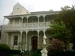 Late Victorian style double storey house. Hipped gable pitched roof with fibre cement slates. Double storey bay to left hand side of facade. Double storey cast iron filigree verandah intact. Ashlar plasterwork, quoining and plaster surrounds. Decorative These two impressive double-storey dwelling-houses with their Edwardian and Victorian features were erected in 1910 by George Thomas Hopkins. The magnificent cast- iron verandah and balcony at 66 Hopkins Street were presumably added by Johannes Petrus Ser Type of site: House Current use: House. These two impressive double-storey dwelling-houses with their Edwardian and Victorian features were erected in 1910 by George Thomas Hopkins. The magnificent cast-iron verandah and balcony at 66 Hopkins Street were presumably added by Johannes Petrus Sere