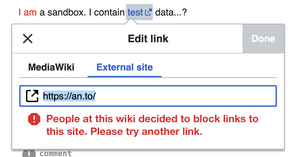 Screenshot showing the feedback people will receive when attempting to link to a blocked domain within the visual editor.