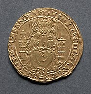 Gold coin showing a man seated on a chair