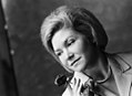 Black-and-white photograph of Nora Brockstedt in 1962 holding a rose.