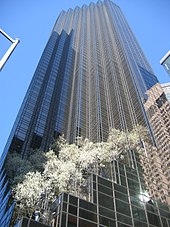 a view upward toward the top of the Trump Tower, a 58-floor building with a brown-glassed facade