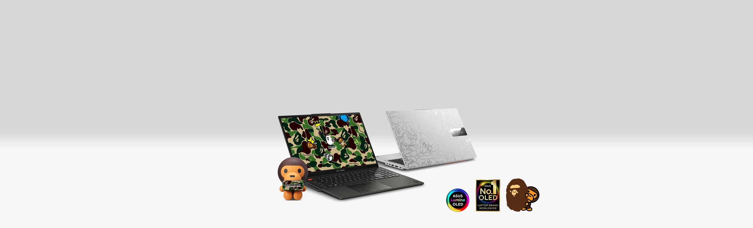 The banner shows two asus vivobook s 15 oled bape edition laptop including silver and black along with the baby milo figurine. Also, there logos including the collaboration logo, ASUS Lumina OLED logo and No.1 OLED logo at the right corner of the banner.