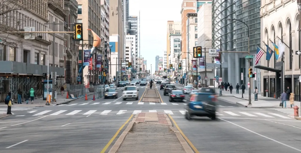 A busy city street with traffic stopped at a traffic light