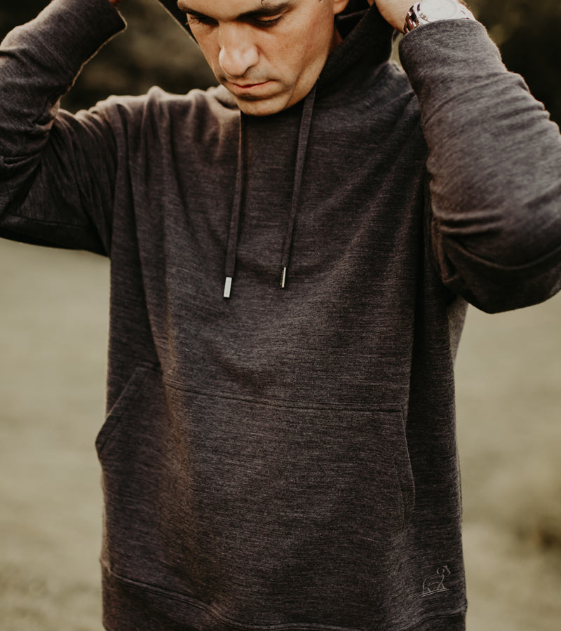 Man wearing chase hoodie while standing in field