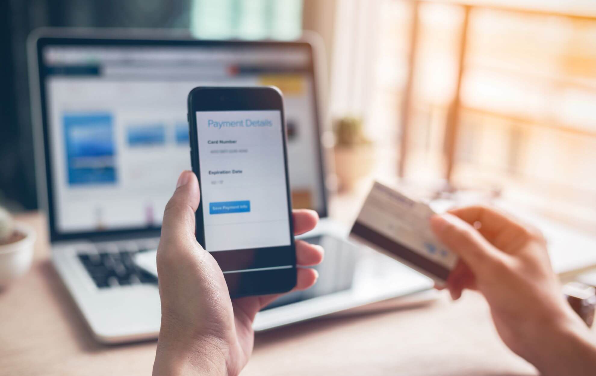 Person setting up a payment using their debit card and phone