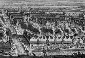 Bird's eye view of part of the city of Batavia where there is fighting while houses stand in flames in the foreground at the time of the massacre of the Chinese in 1740.