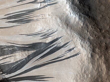 Traînées noires photographiées le 3 décembre 2006 par l'instrument HiRISE de MRO dans la région d'Acheron Fossae.