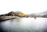 A long stone bridge crossing a lake.