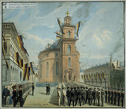 Romanesque church, men marching into it, through a phalanx of uniformed men, houses and church are draped in banners and flags