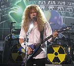 Dave Mustaine pendant la tournée Rust in Peace Live. Les chansons Hangar 18 et Holy Wars... The Punishment Due sont jouées à chaque concert. Il est le seul à avoir contribué à l'écriture de l'album.