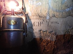 Inscription mentionnant la provenance de la chaux constitutive des joints de ce mur de consolidation dans les Catacombes de Paris.