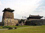 Wall, tower and roofs of one larger building of a fortress.