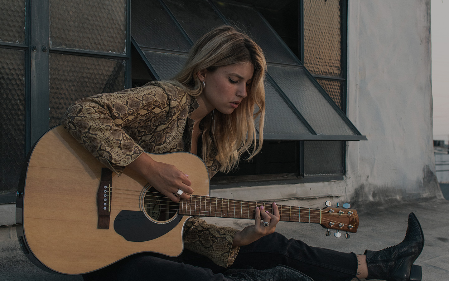 girl playing acoustic guitar