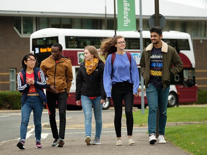 five students walking on campus